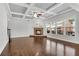 Living room with a stone fireplace, large windows, and a coffered ceiling at 431 La Perla Dr, Sugar Hill, GA 30518