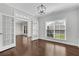 Open living space with hardwood floors, large windows, and French doors at 431 La Perla Dr, Sugar Hill, GA 30518