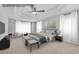 Spacious main bedroom with tray ceiling, ceiling fan, bench, sitting area, and natural light at 431 La Perla Dr, Sugar Hill, GA 30518