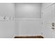 Mudroom boasts wainscoting, three coat hooks, and exterior door at 431 La Perla Dr, Sugar Hill, GA 30518