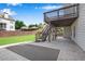 Exterior stone patio with wooden staircase in backyard at 431 La Perla Dr, Sugar Hill, GA 30518
