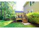 The backyard of the home features a wooden deck with stairs leading to the grassy yard at 51 Vienna Way, Douglasville, GA 30134