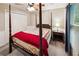Cozy bedroom featuring a four-poster bed with a decorative quilt and an adjacent nightstand with lamp at 51 Vienna Way, Douglasville, GA 30134