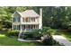 Aerial view of a house with a well-manicured lawn and mature trees at 51 Vienna Way, Douglasville, GA 30134