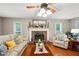 Inviting living room featuring a brick fireplace, hardwood floors, and neutral color palette at 51 Vienna Way, Douglasville, GA 30134