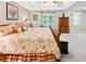 Spacious main bedroom with a king bed featuring floral comforter and decorative pillows and multiple windows at 51 Vienna Way, Douglasville, GA 30134