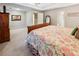 Spacious main bedroom with a king bed featuring floral comforter and decorative pillows and a large mirror in background at 51 Vienna Way, Douglasville, GA 30134