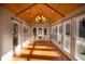 Bright sunroom featuring a wood ceiling, large windows, and natural light at 51 Vienna Way, Douglasville, GA 30134