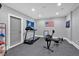 Spacious basement area featuring exercise equipment, and grey walls and floors at 511 Etris Ct, Roswell, GA 30075