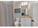 Bathroom featuring granite countertops, white cabinets, and a shower with a gray curtain at 511 Etris Ct, Roswell, GA 30075