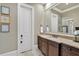 Bathroom featuring granite countertops, dark wood cabinetry, and a large mirror at 511 Etris Ct, Roswell, GA 30075