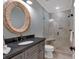 Bathroom boasts a new vanity with a framed mirror and a glass enclosed shower with new tile at 511 Etris Ct, Roswell, GA 30075