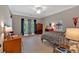 Bedroom with a large window, desk, carpet, and neutral colored walls at 511 Etris Ct, Roswell, GA 30075