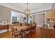 Elegant dining room with hardwood floors, modern chandelier, and neutral paint at 511 Etris Ct, Roswell, GA 30075