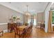 Charming dining room with hardwood floors, chandelier, and ample natural light at 511 Etris Ct, Roswell, GA 30075