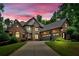 Stunning brick home with stone accents, three-car garage, basketball hoop, and well-manicured lawn at 511 Etris Ct, Roswell, GA 30075