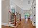 Hallway with hardwood floors, decorative iron railing, and abundant natural light at 511 Etris Ct, Roswell, GA 30075