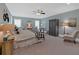 Spacious main bedroom featuring a ceiling fan, sitting area, a wardrobe and neutral paint at 511 Etris Ct, Roswell, GA 30075