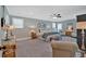 Spacious main bedroom featuring a ceiling fan, sitting area, a bench at the foot of the bed, and neutral paint at 511 Etris Ct, Roswell, GA 30075