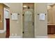 Modern bathroom with a glass-enclosed shower, neutral tile, and updated fixtures at 511 Etris Ct, Roswell, GA 30075