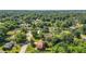 An aerial view showcases this charming single-Gathering home's spacious and well-maintained lawn and surrounding trees at 618 Nw Summerville Dr, Lawrenceville, GA 30046