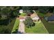Aerial view of a home with a large front yard, driveway, and back yard with a shed and mature trees at 618 Nw Summerville Dr, Lawrenceville, GA 30046