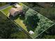 Aerial view of a home with mature trees, a backyard pool, and a storage shed at 618 Nw Summerville Dr, Lawrenceville, GA 30046