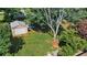 View of a backyard featuring a metal garage shed and mature trees at 618 Nw Summerville Dr, Lawrenceville, GA 30046