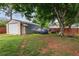 Large backyard with a metal shed, wood fence, mature trees, and ample parking at 618 Nw Summerville Dr, Lawrenceville, GA 30046
