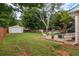 Well-maintained backyard with a wood fence, detached shed, and patio seating area at 618 Nw Summerville Dr, Lawrenceville, GA 30046