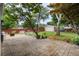 Paver patio with a hammock, seating, and a view of the spacious, fenced backyard with mature trees and a shed at 618 Nw Summerville Dr, Lawrenceville, GA 30046