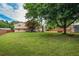 Expansive backyard with mature trees, wood fence, and a glimpse of the home's rear exterior at 618 Nw Summerville Dr, Lawrenceville, GA 30046