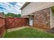Side yard with a wood gate, brick exterior, and access to the home at 618 Nw Summerville Dr, Lawrenceville, GA 30046