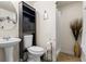 Small bathroom features a pedestal sink, storage cabinet, toilet and shower at 618 Nw Summerville Dr, Lawrenceville, GA 30046