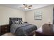 A well-lit bedroom with a double bed, matching nightstands and dresser at 618 Nw Summerville Dr, Lawrenceville, GA 30046