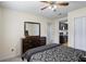 Bedroom showcasing a large wooden dresser, mirror and doorway view into the kitchen at 618 Nw Summerville Dr, Lawrenceville, GA 30046