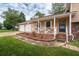 Charming front porch with white railing and two-car garage, perfect for relaxing outdoors at 618 Nw Summerville Dr, Lawrenceville, GA 30046