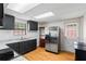 Bright kitchen features stainless steel appliances, dark cabinets and wood flooring at 618 Nw Summerville Dr, Lawrenceville, GA 30046