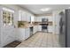 Bright kitchen features white cabinets, stainless steel appliances, and tile flooring for a clean and modern feel at 618 Nw Summerville Dr, Lawrenceville, GA 30046