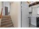Basement laundry area with washer, tile floor, and access to the stairs, offering convenience at 618 Nw Summerville Dr, Lawrenceville, GA 30046