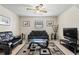 Comfortable living room with neutral walls, ceiling fan, dark sofas and carpeted floors at 618 Nw Summerville Dr, Lawrenceville, GA 30046