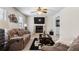 Comfortable living room with fireplace, ceiling fan, and plush seating, perfect for relaxation at 618 Nw Summerville Dr, Lawrenceville, GA 30046