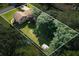 Aerial view of the property showing the backyard, pool, shed, and mature trees surrounding the house at 618 Summerville Dr, Lawrenceville, GA 30046