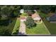 Aerial view of a home with a two-car garage, outbuilding, mature trees, and well-maintained landscaping at 618 Summerville Dr, Lawrenceville, GA 30046
