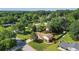 Aerial view of a property with mature trees, lush green lawns, a home, and a swimming pool at 618 Summerville Dr, Lawrenceville, GA 30046