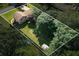 Aerial view of a home with mature trees, a swimming pool, and a storage shed at 618 Summerville Dr, Lawrenceville, GA 30046