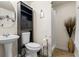 A bathroom features a pedestal sink, a black storage cabinet, and a shower with a curtain at 618 Summerville Dr, Lawrenceville, GA 30046