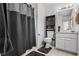 Bathroom featuring a tub with dark curtain, modern vanity with great lighting, and tile flooring at 618 Summerville Dr, Lawrenceville, GA 30046