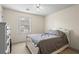 Bright bedroom with plush carpet, ceiling fan, and large window with views of the neighborhood at 618 Summerville Dr, Lawrenceville, GA 30046