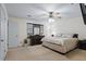 Spacious bedroom with soft carpet, a ceiling fan, and large dresser with decorative mirror at 618 Summerville Dr, Lawrenceville, GA 30046